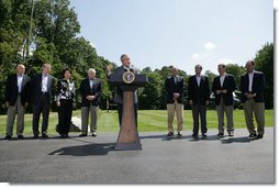 President George W. Bush gestures as he addresses his remarks to the media Friday, Aug. 18, 2006 in Camp David, Md., following a meeting with his economic advisors, from left to right, Edward P. Lazear chairman Council of Economic Advisors; Rob Portman, director of the Office of Management & Budget; U.S. Secretary of Labor, Elaine Chao; Vice President Dick Cheney; U.S. Secretary of the Treasury Henry M. Paulson; U.S. Sec. of Commerce Carlos Gutierrez; U.S. Secretary of Health & Human Services Michael O. Leavitt and Allan Hubbard, director of the National Economic Council.  White House photo by David Bohrer