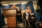 Sharing the stage with several White House Press Secretaries, President George W. Bush jokes with reporters in the James S. Brady Press Briefing Room Wednesday, August 2, 2006. It was the last press briefing before the room undergoes extensive renovations. Pictured at the President’s right is Press Secretary James S. Brady, who was wounded during an assassination attempt on President Reagan. The room is named in his honor. White House photo by Eric Draper