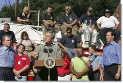 President George W. Bush discusses the recovery efforts at the Millvale, Pa. Fire Department in Western Pennsylvania during a visit to the area recently flooded by Tropical Depression Ivan in Allegheny County, Wednesday, Sept. 22, 2004.  White House photo by Eric Draper