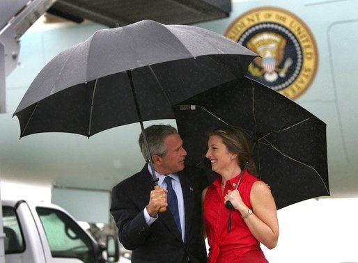 President George W. Bush talks with USA Freedom Corps Greeter Crystal Regan after arriving aboard Air Force One at Charlotte-Douglas International Aiport - Air National Guard Base, Friday, Sept. 17, 2004. Ms. Regan volunteers at East Lincoln Pregnancy Counseling Center, teaching parenting, nutrition, budgeting classes and counseling clients with unplanned pregnancies. White House photo by Eric Draper