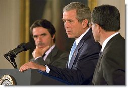 President George W. Bush speaks as European Union President and Spanish Prime Minister Jose Maria Aznar (left) and the European Commission President Romano Prodi listen during a new conference in the East Room of the White House, Thursday, May 2, 2002. White House photo by Paul Morse.