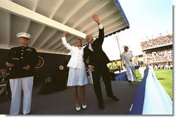 After speaking at the United States Naval Academy commencement, Vice President Dick Cheney waves with a graduate to her family in the stadium May 24, 2002.  White House photo by David Bohrer