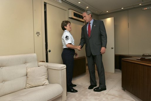 President George W. Bush meets Freedom Corps Greeter Master Sergeant Gina Carnesecchi aboard Air Force One after arriving at MacDill Air Force Base in Tampa, Florida, Wednesday, June 16, 2004. Sgt. Carnesecchi founded Operation Lighthouse, a program at MacDill AFB to support troops who are deployed overseas. White House photo by Eric Draper.