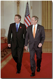 President George W. Bush and Prime Minister Tony Blair of England walk out to address the media in Cross Hall at the White House Nov. 7. "We've got no better friend in the world than Great Britain," said the President during his remarks. White House photo by Paul Morse.