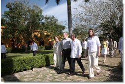 President George W. Bush and Mrs. Laura Bush walk with President Felipe Calderon and Mrs. Margarita Zavala to the arrival ceremonies Tuesday, March 13, 2007, in Temozon Sur, Mexico. The President and Mrs. Bush are on the final leg of their five-country, Latin American visit, and are scheduled to return to Washington Wednesday.  White House photo by Paul Morse