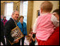 President George W. Bush and Mrs. Laura Bush greet the family members of former President Lyndon Baines Johnson in the Oval Office, Friday, March 23, 2007, for the signing of H.R. 584 designating the U.S. Department of Education in Washington, D.C., as the Lyndon Baines Johnson Federal Building. President Bush holds an old photo of President Johnson and Lady Bird Johnson to show members of the Johnson family. White House photo by Eric Draper
