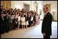 President George W. Bush greets the 2005 Presidential Scholars during a group photo shoot in the East Room June 27, 2005. Chosen from more than 2,700 high school candidates, 141 scholars are honored for their accomplishments in academics and the arts. White House photo by Eric Draper