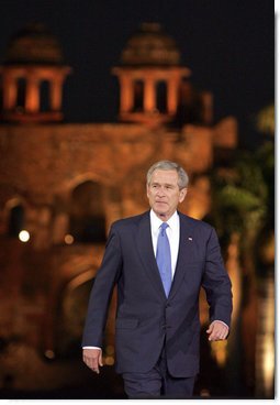 President George W. Bush acknowledges the audience as he arrives for remarks Friday, March 3, 2006, at the Purana Qila in New Delhi.  White House photo by Paul Morse