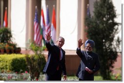 President George W. Bush and Prime Minister Manmohan Singh of India wave as they leave Mughal Garden at the Hyderabad House after a press availability in New Delhi Thursday, March 2, 2006.  White House photo by Paul Morse