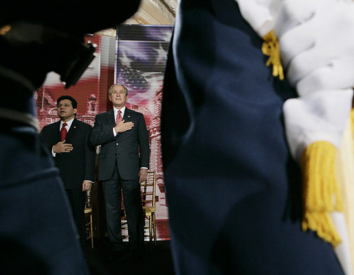 President George W. Bush and U.S. Attorney General Alberto Gonzales are framed by a military honor guard Monday, March 27, 2006, during the Naturalization Ceremony at the Daughters of the American Revolution Administration Building in Washington. President Bush, speaking to those who were swearing-in as new U.S. citizens, said that each generation of immigrants brings a renewal to our national character and adds vitality to our culture. White House photo by Eric Draper