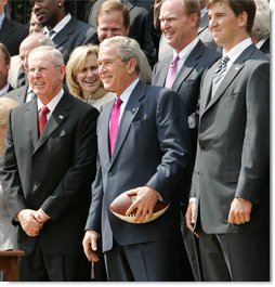 President George W. Bush smiles as he holds a football presented to him by New York Giants Coach Tom Coughlin and Quarterback Eli Manning Wednesday, April 30, 2008, during an event on the South Lawn celebrating the Giants 17-14 Super Bowl win in February. White House photo by Chris Greenberg