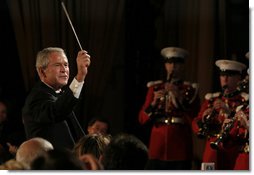 President George W. Bush leads the Marine Band Saturday, April 26, 2008, during the 94th Annual White House Correspondents' Association Dinner at the Washington Hilton Hotel.  White House photo by Joyce N. Boghosian