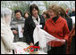 Mrs. Laura Bush spends a moment with a traditional handicraft artisan at Dimitrie Gusti Village during an outing Thursday, April 3, 2008, with NATO spouses to the Bucharest open-air museum. White House photo by Shealah Craighead