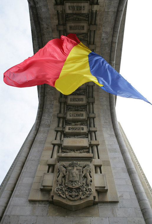The flag of Romania hangs proudly from the Arcul de Triumf, a 27-meter high arch located in north Bucharest, site of the 2008 NATO Summit. White House photo by Chris Greenberg