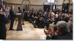 President George W. Bush and members of the audience acknowledge Thomas Boyd, at right in dark shirt, after the President mentioned him in remarks Wednesday, April 9, 2008, during the signing of H.R. 1593, the Second Chance Act of 2007. The Second Chance Act aims to reduce prison populations and corrections costs by reducing the recidivism rate by providing federal funding to develop programs dealing with job training, substance abuse, and family stability. In acknowledging Mr. Boyd, a 53-year-old graduate of the Jericho re-entry program in Baltimore, the President said, "I want to thank you for coming, Thomas. There's a lot of other Thomases out there that we're going to help with this bill."  White House photo by Eric Draper