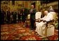 The President and first lady stand and applaud the Pope during their audience with him in June 2004 at which the President presented the Pope with the Medal of Freedom. White House photo by Eric Draper