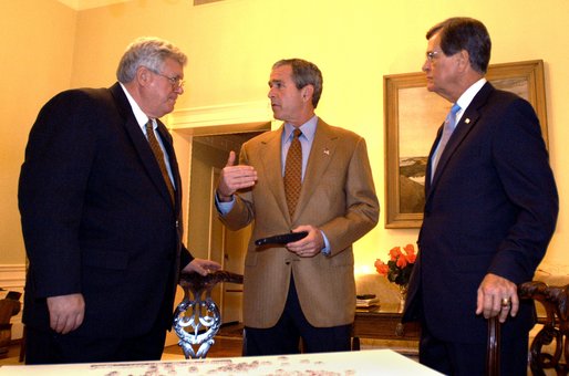 President George W. Bush talks with House Speaker Dennis Hastert and Senate Republican Leader Trent Lott while watching election returns in the White House residence Tuesday night, Nov. 5, 2002. White House photo by Eric Draper