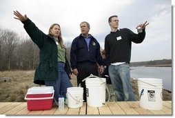 President George W. Bush participates in a water testing project with Education Director Laura Lubelczyk, left, and volunteer Trak Lord at the Wells National Estuarine Research Reserve with in Wells, Maine, Thursday, April 22, 2004. In his remarks, President Bush discussed the value of volunteering in places like the reserve, "But what makes this beautiful part of the world go is the 400 volunteers who work here -- the 400 volunteers who are exercising their responsibility as citizens to make this beautiful part of the world even more beautiful and more meaningful."  White House photo by Eric Draper