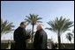 Vice President Dick Cheney speaks with Zalmay Khalilzad, US Ambassador to Iraq, inside the Green Zone, Sunday Dec. 18, 2005. White House photo by David Bohrer