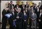 President Bush reacts with a joke as he is given a Speedo swim suit Tuesday, July 12, 2005 by members of the UCLA men's waterpolo team, who were attending ceremonies to honor NCAA 2004-2005 national championship teams. White House photo by David Bohrer