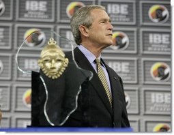 President George W. Bush stands on stage before receiving the Indiana Black Expo Lifetime Achievement Award at the Indiana Black Expo Corporate Luncheon in Indianapolis, Indiana, Thursday, July 14, 2005.  White House photo by Eric Draper