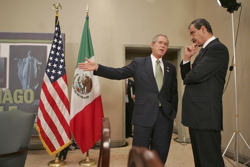 President George W. Bush talks with Mexican President Vicente Fox at the 2004 APEC summit in Santiago, Chile, Nov. 21, 2004. White House photo by Eric Draper
