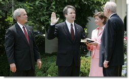 President George W. Bush looks on as Justice Anthony Kennedy swears in Brett Kavanaugh to the U.S. Court of Appeals for the District of Columbia during a ceremony Thursday, June 1, 2006, in the Rose Garden. Mrs. Ashley Kavanaugh holds the Holy Bible. White House photo by Eric Draper