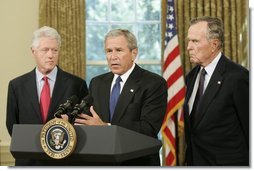 Standing with former Presidents Bill Clinton and George H. W. Bush, President George W. Bush discusses the plans to help people affected by Hurricane Katrina in the Oval Office Sept. 1, 2005. "We're working hard to repair the breaches in the levees. Federal, state, and local agencies are also cooperating to sustain life," President Bush. "That means getting food and water to those who are stranded. Medical personnel and local officials are helping hospital patients and people gathered in the Superdome to evacuate."  White House photo by Paul Morse