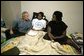 President George W. Bush visits with a family displaced by Hurricane Katrina, during his visit Monday, Sept. 5, 2005 at the Bethany World Prayer Center shelter in Baton Rouge, La. White House photo by Eric Draper