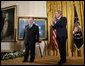 President George W. Bush applauds Korean War era veteran Corporal Tibor "Ted" Rubin, after awarding Rubin the Medal of Honor, Friday, Sept. 23, 2005 at cermonies at the White House in Washington. Rubin was honored for his actions under fire, and his bravery while in captivity at a Chinese POW camp. White House photo by Paul Morse