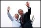 After receiving her degree from President George W. Bush, a cadet and the President wave to the gathered crowd during the United States Coast Guard Academy Commencement in New London, Conn., Wednesday, May 21, 2003. White House photo by Eric Draper.