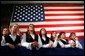 Members of the Hampden Academy Chamber Choir listen to President George W. Bush during the Maine Welcome in Bangor, Maine, Tuesday, Oct. 22. White House photo by Eric Draper.