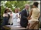 President George W. Bush greets Tamara Brooks after signing the S. 151, PROTECT Act of 2003, in the Rose Garden Wednesday, April 30, 2003. Brooks, 17, was rescued after an AMBER Alert was issued throughout Orange County, Calif., alerting the community of her abduction. Donna Norris, left, embraces her son Ricky after the bill signing. The AMBER Alert system is named in honor of her 9-year-old daughter, Amber Hagerman, who was abducted while playing near her Arlington, Texas, home and later found murdered. White House photo by Paul Morse