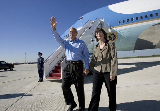 President George W. Bush walks away from Air Force One with USA Freedom Corps Greeter Cheryl Hornung at Lehigh Valley International Airport in Allentown, Pa., Friday, Oct. 1, 2004. Hornung founded Caitlin's Smiles in March of 2004, which provides toys to children with life-threatening illnesses while they are awaiting medical procedures. The program was inspired by Hornung's daughter, Caitlin, who lost her battle with cancer four years ago. White House photo by Eric Draper.