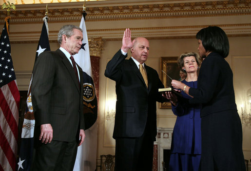 President George W. Bush looks on as Secretary of State Condoleezza Rice administers the oath of office to Deputy Secretary of State John Negroponte Tuesday, Feb. 27, 2007, in the Benjamin Franklin Room at the U.S. Department of State. Holding the Bible for the ceremonial swearing-in is Dr. Diana Negroponte, wife of Secretary Negroponte. White House photo by Paul Morse