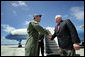 Vice President Dick Cheney is greeted by Brigadier General Doug Owens, Commander, 36th Wing, Thursday, Feb. 22, 2007, upon arrival to Andersen Air Force Base, Guam, for a rally with U.S. troops. White House photo by David Bohrer