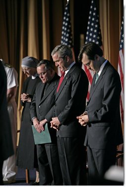 President George W. Bush joins his hosts in prayer while attending the National Catholic Prayer Breakfast in Washington, D.C., Friday, May 20, 2005.  White House photo by Eric Draper
