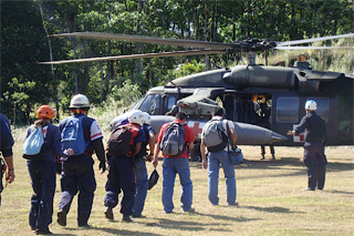 Costa Rican rescue workers board U.S. Army Blackhawk helicopters, transporting them to the epicenter to assist earthquake victims