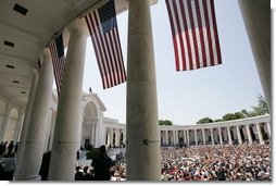 Thousands of people gather to pay their respects on Memorial Day at the amphitheatre in Arlington National Cemetery in Arlington, Va., May 30, 2005.  White House photo by Paul Morse