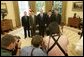 President George W. Bush welcomed the crew members and families of the International Space Station expeditions 7, 8, 9 and 10 to the Oval Office Tuesday, May 31, 2005. Standing for photos with the President from left are: Lt. Colonel Mike Fincke, ISS 9; Dr. Edward Lu, ISS 7; Dr. Leroy Chiao, ISS 10, and Dr. Michael Foale, ISS 8. White House photo by Eric Draper