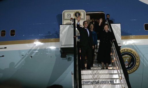 Waving to the crowd, President and Mrs. Bush and Latvia's President Vaira Vike-Freiberga deplane Air Force One Friday night, May 6, 2005, after the Bushes arrived in Riga, Latvia for the first of four European stops. White House photo by Eric Draper