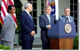 President George W. Bush discusses his plan for peace in the Middle East as Dr. Condoleezza Rice (left), Sec. Colin Powell (center) and Sec. Donald Rumsfeld stand by his side in the Rose Garden Monday June 24. White House photo by Paul Morse.
