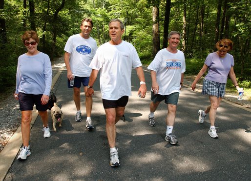 President George W. Bush and First Lady Laura Bush complete a four mile walk with brother Marvin Bush, left, Chief of Staff Andy Card and wife Kathleene after undergoing a colorectal screening procedure at Camp David, Saturday morning, June 29. White House photo by Eric Draper.