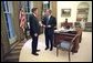 President George W. Bush meets with his new Director of Homeland Security Tom Ridge in the Oval Office shortly before swearing Mr. Ridge in for the position at a White House ceremony Monday, Oct. 8. White House photo by Eric Draper.