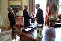 President George W. Bush welcomes retired New York firefighter Bob Beckwith and his wife Barbara to the Oval Office Feb. 25. Mr. Beckwith and New York Governor George Pataki visited the White House to present the President with the bullhorn the President used to talk with recovery workers during a visit to the World Trade Center Sept. 14, 2001. 