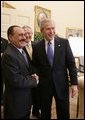 President George W. Bush welcomes Yemen President Ali Abdullah Saleh into the Oval office of the White House, Thursday, Nov. 10, 2005. Interpreter Gamal Helal is seen in background. White House photo by Eric Draper