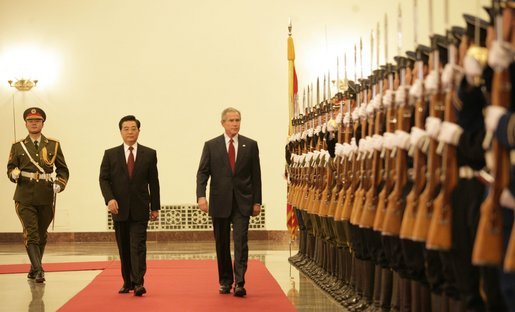 President George W. Bush and President Hu Jintao of the People's Republic of China, view Chinese troops during the welcome ceremonies for the President and Mrs. Bush at the Great Hall of People in Beijing. White House photo by Eric Draper