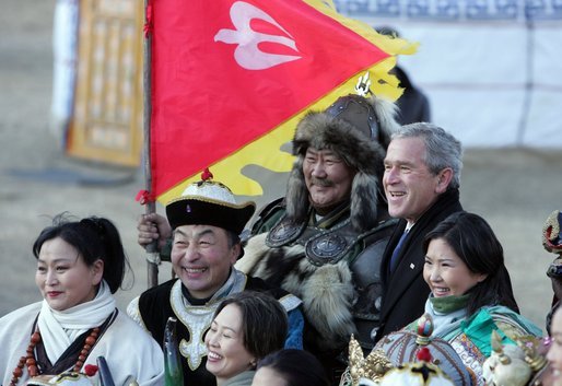 President George W. Bush poses for photos with a Mongolia horseman and other participants of a cultural event in Ikh Tenger, near the capital city of Ulaanbaatar, during a visit Monday, Nov. 21, 2005, by the President and Mrs. Bush. White House photo by Paul Morse