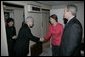 As President Bush looks on, Mrs. Laura Bush shakes hands with Japanese Ambassador to the United States Ryozo Kato and his wife, Hanayo, as the couple greeted the President and First Lady upon their arrival Tuesday, Nov. 15, 2005, to Osaka International Airport. White House photo by Eric Draper