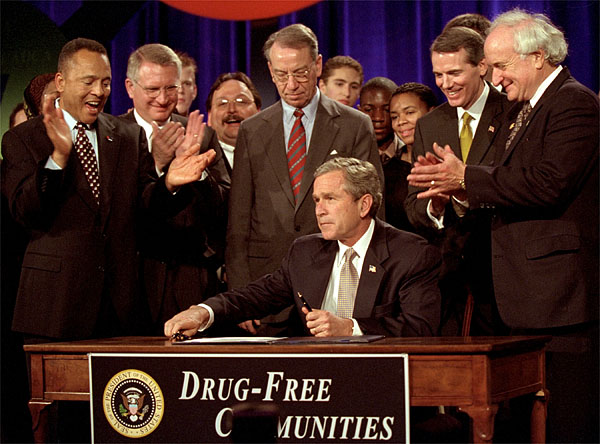 President George W. Bush signs the Drug-Free Communities Act to help individual communities fight drug abuse Dec. 14. "You're a part of America's armies of compassion, examples of service and citizenship," said the President in his remarks at a meeting of the Community Antidrug Coalitions of America. "You restore hope to lives, and safety to neighborhoods." White House photo by Eric Draper.